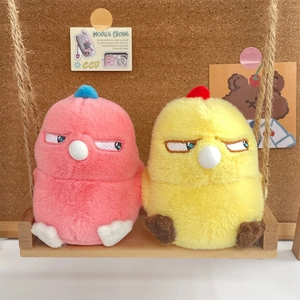 Close-up of pink and yellow plush bird charms sitting on a mini wooden swing