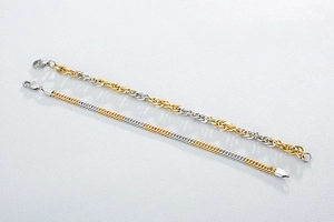 Macro detail of two-tone gold and silver chain links with secure lobster clasps