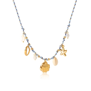 Detail of woven rope necklace with gold shell, starfish, and pearl charms in beach style