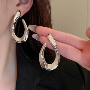 Silver twisted geometric earrings with abstract organic shapes for a modern fashion statement