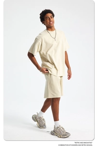 Detail of premium heavy cotton oversized t-shirt and drawstring shorts set in beige