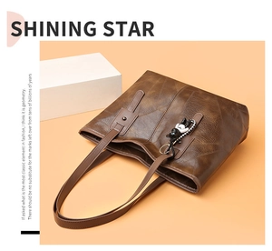 Detailed view of brown tote bag with geometric texture and cute panda charm