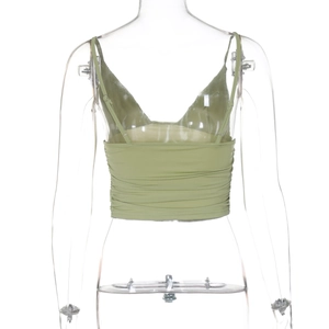 Detail view of the light green cropped camisole featuring a smocked ruched back design