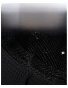 Detail of breathable mesh lining and wide sweatband inside the black outdoor sun hat