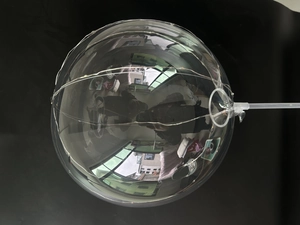 Detail of transparent LED glowing bobo balloon with copper wire fairy lights and white handle