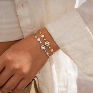 Elegant gold and silver snowflake zircon adjustable bracelets worn by a model