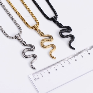 Detailed view of snake pendants in silver, gold and black with box chains and scales