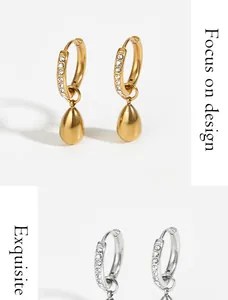 Detail of gold and silver water drop earrings with micro-set clear zircon stones