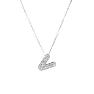 Macro shot of silver zircon pavé V-letter pendant necklace with hip hop aesthetic style