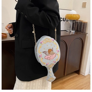 Detail of light blue mirror-shaped bag with gold chain and angel embroidery