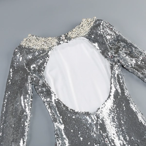 Detail of silver sequin evening dress with pearl neckline and open back design