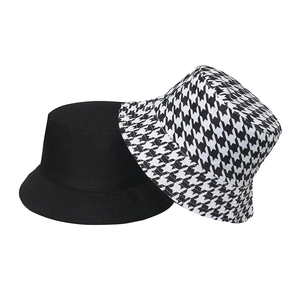 Reversible houndstooth and black bucket hat for sun protection and casual outdoor style