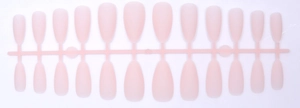 Macro detail of 24 pieces matte almond press-on nails in nude pink on a plastic rack