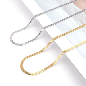 Detailed view of classic gold and silver flat snake bone chains with metallic texture