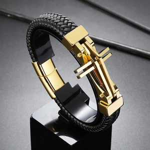 Detailed shot of black woven leather strap and golden cross-shaped buckle on men's bracelet