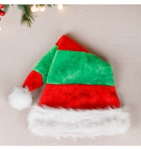 Close-up of red and green striped plush Santa hat with white faux fur trim and pompom
