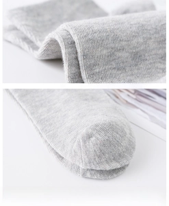 Close-up of hand-linked seamless toe on light grey cotton socks with fine knit texture