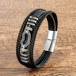 Detail of multi-layer leather bracelet with horseshoe buckle and blue zircon stones