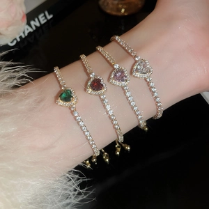 Macro detail of heart-shaped colorful zircon bracelets in various colors on wrist