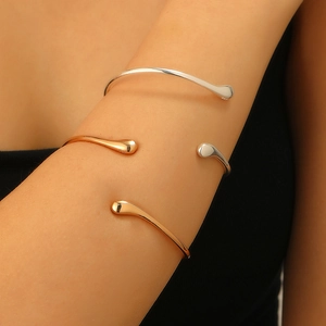 Minimalist liquid lava open arm cuff set with water drop ends in gold and silver finish
