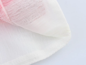 Detailed close-up showing white chiffon fabric texture and pink lining with fine stitching