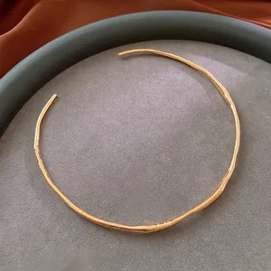 Luxurious gold plated wavy choker necklace with irregular texture and open cuff design