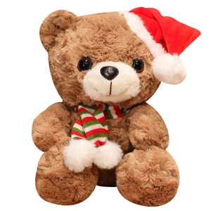 Brown Christmas teddy bear plush with red hat and striped scarf on white background