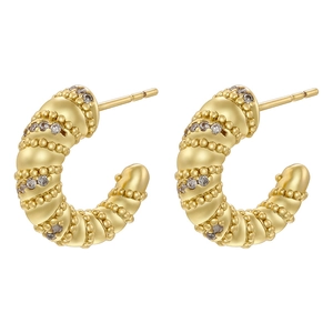 Golden C-shaped hoop earrings with textured ribbed design and sparkling zircons
