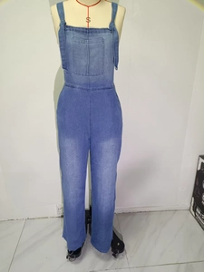 Detail of blue denim jumpsuits with wide shoulder straps and large front chest pocket