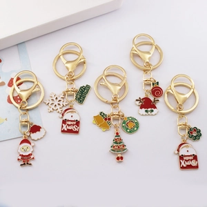 Detail view of five gold-toned alloy Christmas keychains with colorful enamel charms