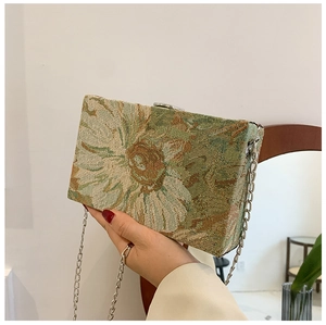 Detail of floral tapestry box bag with vintage jacquard pattern and silver chain strap