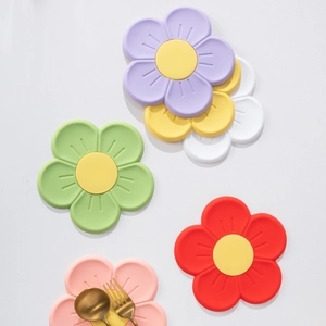 Colorful sunflower-shaped heat resistant silicone coasters and pot mats in a set