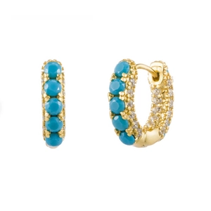 Macro shot of gold hoop earrings with turquoise stones and white zircon accents