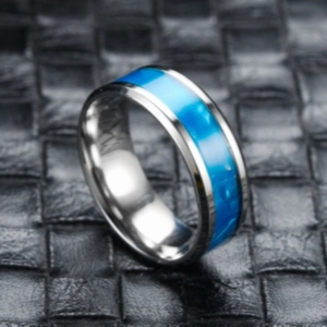 High-quality close-up detail of titanium steel ring featuring a vibrant blue resin inlay
