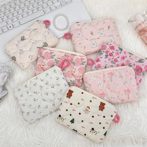 Detailed flat lay of quilted cotton cosmetic bags with cartoon prints and zipper closures