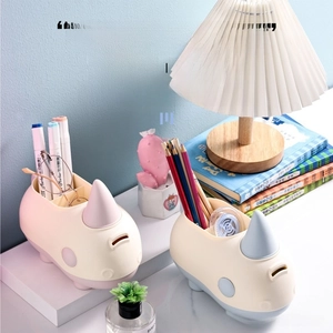 Macro detail of rhino pen holder with three vertical slots for organized desk storage