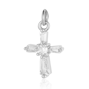 Macro shot of silver-colored cross pendant with clear crystals and a polished metal finish