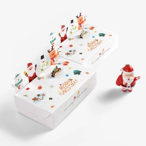 Christmas gift boxes with Santa charms and Merry Christmas printing in festive white design