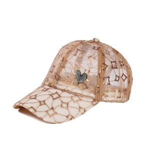 Detail of champagne gold mesh baseball cap with sequined patterns and black enamel heart