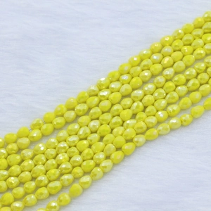 Macro detail of yellow faceted strawberry teardrop beads for DIY jewelry making