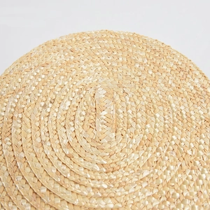 Macro shot of tight spiral straw weaving on a vintage French style sun bucket hat