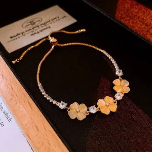 Zircon flower bracelet with artificial cat eye stones and adjustable gold drawstring chain