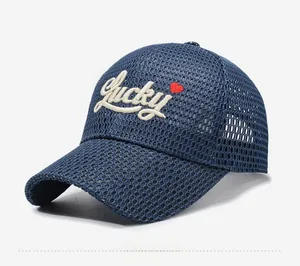 Detail of navy blue mesh baseball cap with white Lucky embroidery and heart