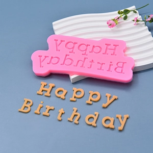 Pink silicone Happy Birthday cake mold for fondant baking decorations shown on blue background