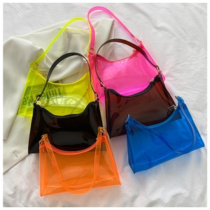 Flat lay view of colorful transparent PVC shoulder bags in six vibrant neon shades