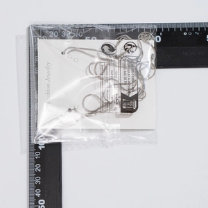 Detail of silver snake chain necklace with Fashion Jewelry display card in packaging