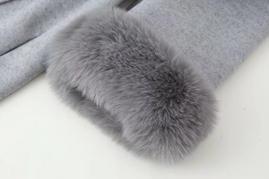 Détail de la bordure en fausse fourrure grise et de la texture du tissu en laine épais