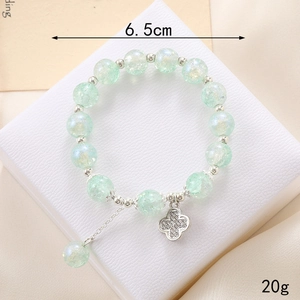 Detail of light green bead bracelet with silver clover charm, weight 20g and size 6.5cm
