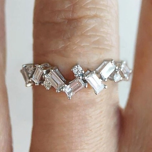Macro shot of silver ring featuring staggered rectangular and round cubic zirconia stones