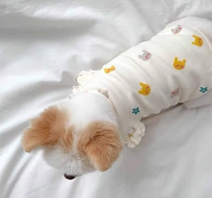 Detail of white cotton dog vest with rabbit print and ruffled flutter sleeves for small pets